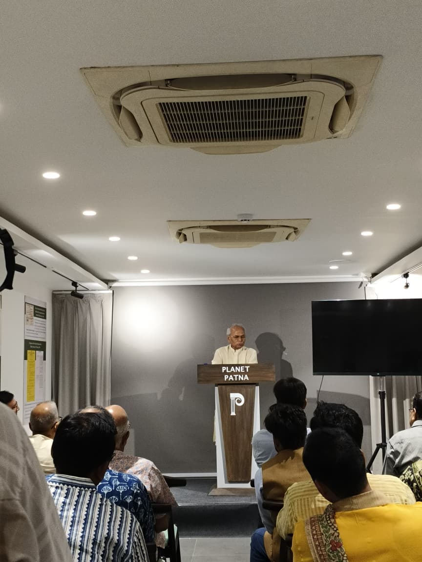 Senior guest speaker sharing reflections at the podium